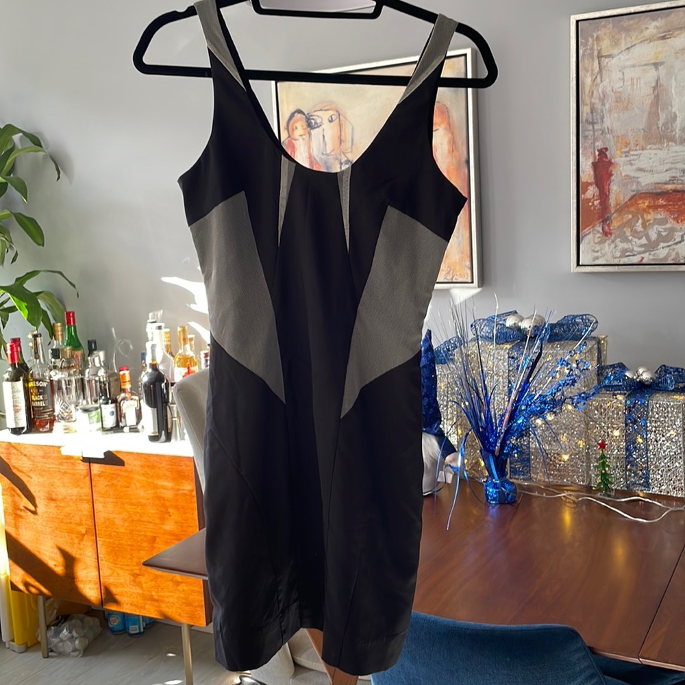 Bebe. Black mini dress with mesh inserts. Size S